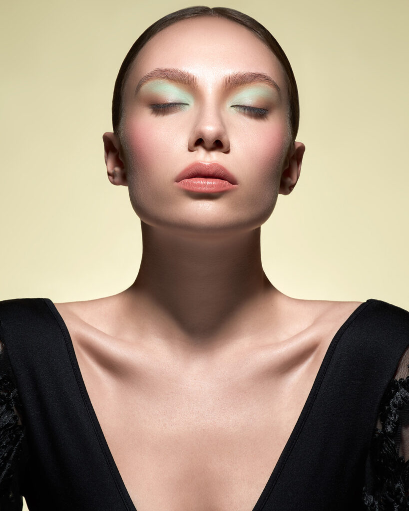 Beauty photos from a young model, closed her eyes and looking up with a beige background