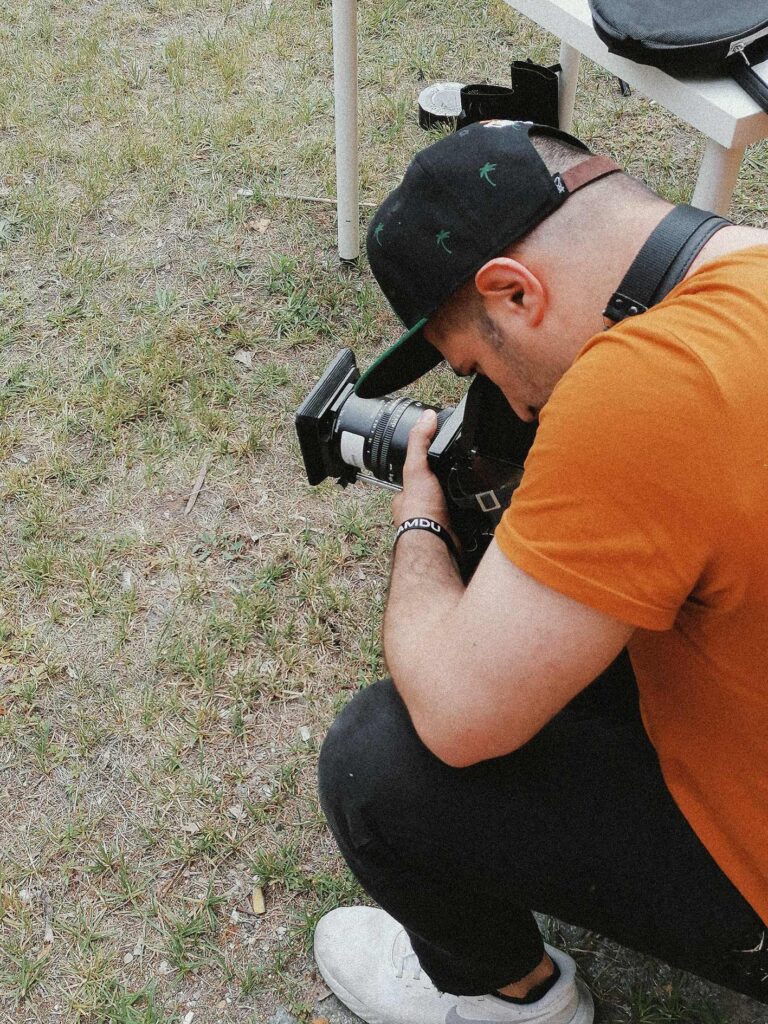 01 outdoor photography backstage from Ed Mehravaran. he is taking analog photos with middle format camera. Mamiya RB67 camera with 250 mm lens. Ed Mehravaran is a Berlin based professional photographer. 