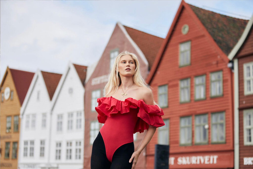 Portrait of Thea in Front of the red Buildings in Bergen-Norway