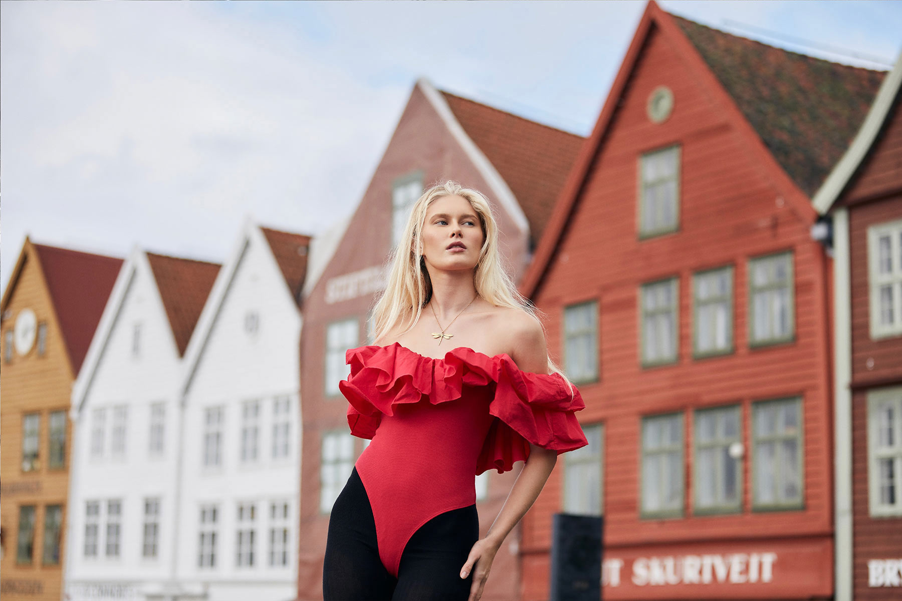 Portrait of Thea in Front of the red Buildings in Bergen-Norway