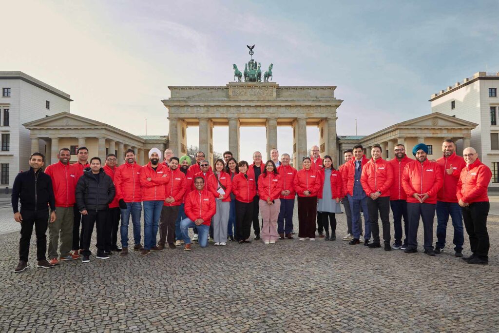 Coca Cola team in front of the Brandenburger tor-Berlin with red outfits.